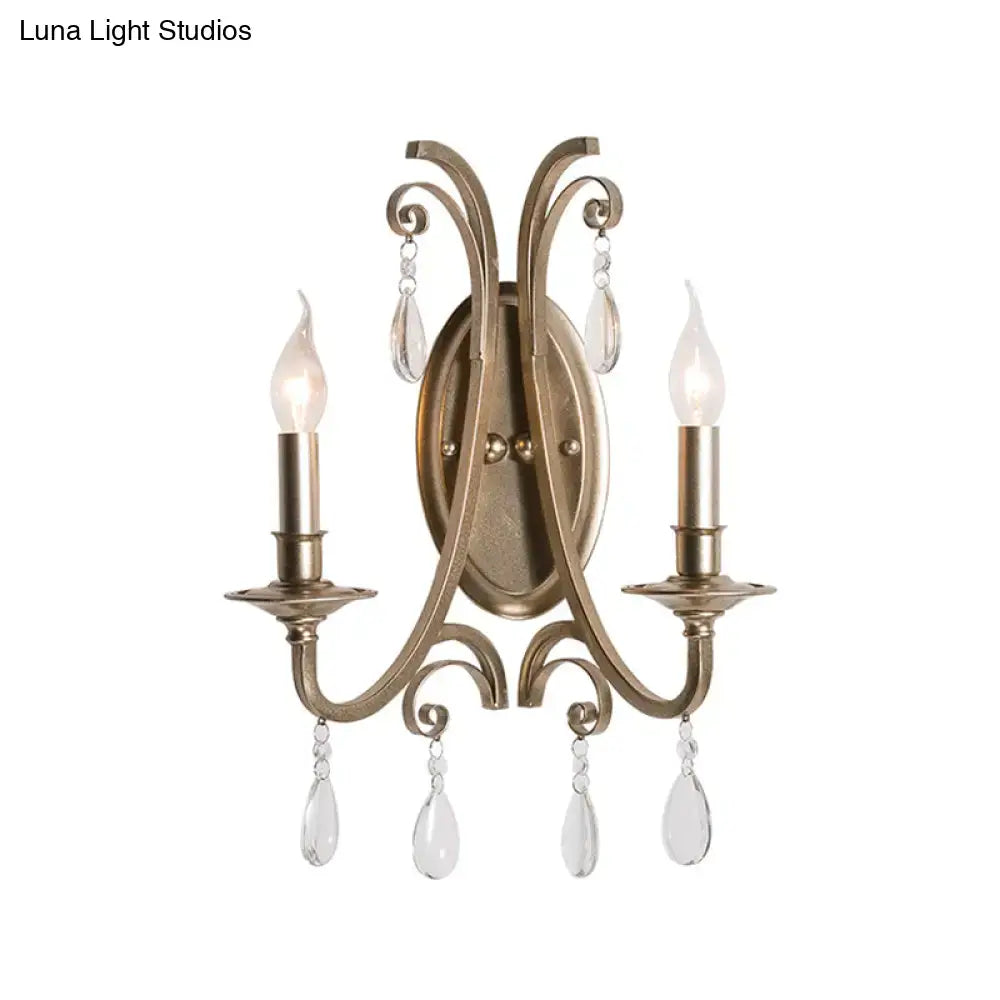 Antique brass two-light sconce light with crystal teardrop pendants in french country brass finish wall lamp design
