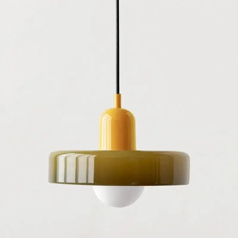 A modern bauhaus style glass pendant lighting with glossy mustard-yellow top and translucent olive-green shade