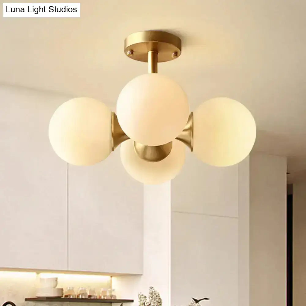 Modern brass-finished semi-flush mount ceiling light with four opaline glass globe shades 220v-240v 110v-120v