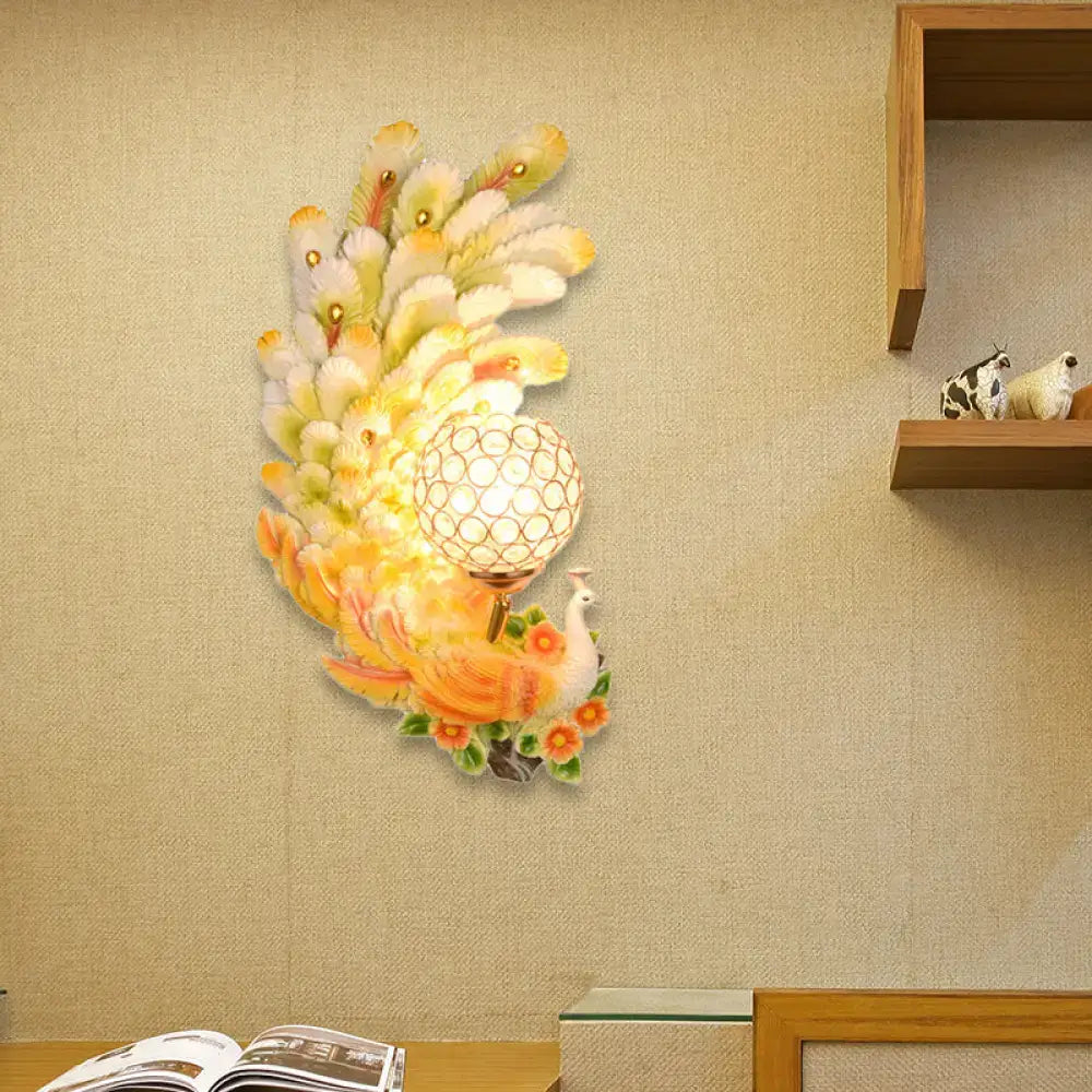 Golden peacock wall light with crystal shade – living room yellow & green