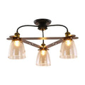 Black metal ceiling lamp with three cognac glass bell shades and brass accents for living room lighting
