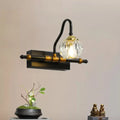 Industrial black and brass hexagon vanity wall lamp with faceted crystal prisms and a crystal globe bulb