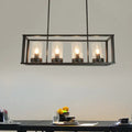 Black metal rectangular pendant light with four clear glass cylinders for kitchen island illumination