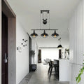 Black industrial farmhouse barn island pendant with three cage-shade lamps and adjustable chain cord length pulley mechanism