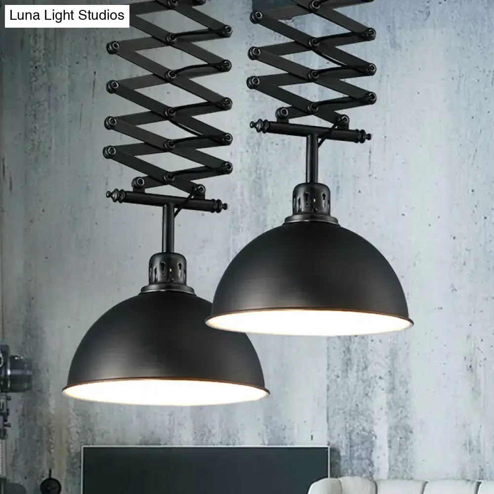 Black industrial-style pendant light with extendable accordion arms and matte dome shades in black white finish