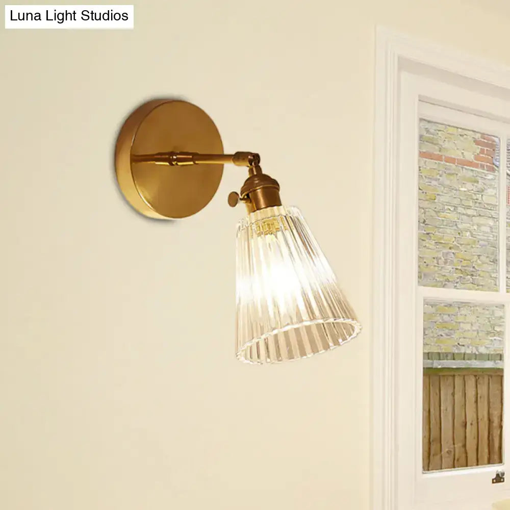 Industrial brass and clear textured glass wall sconce dining room