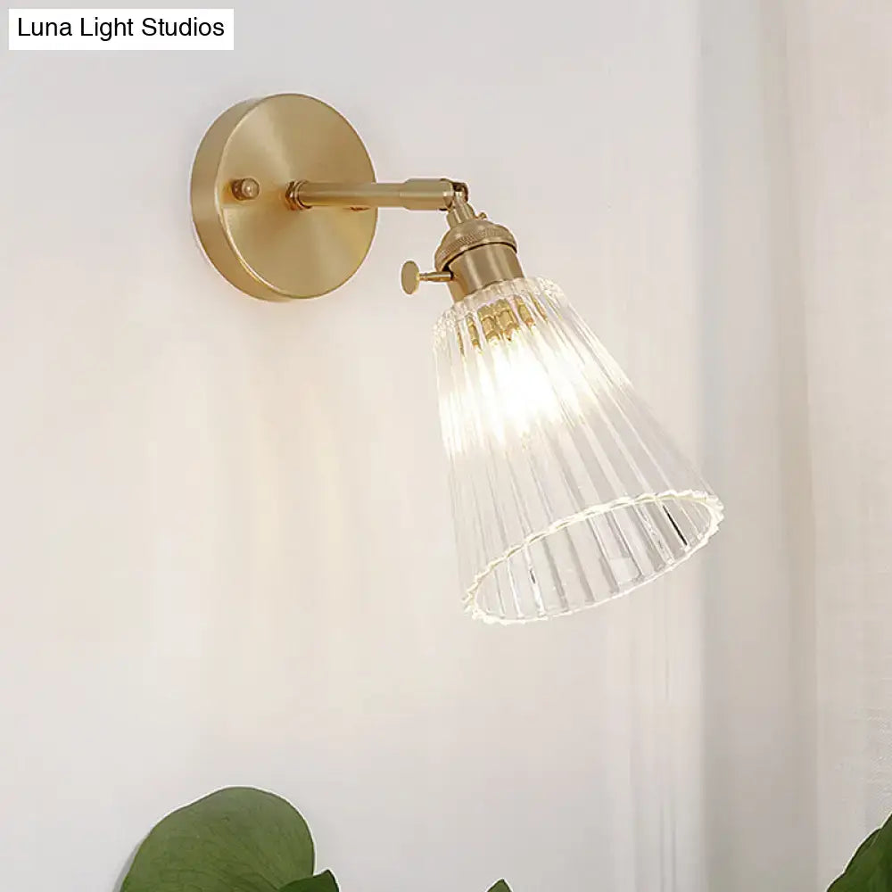 Industrial brass and clear textured glass wall sconce dining room