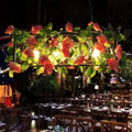 DecorBites™ industrial metal black island pendant light with rectangular frame, artificial pink roses, and warm glowing bulbs