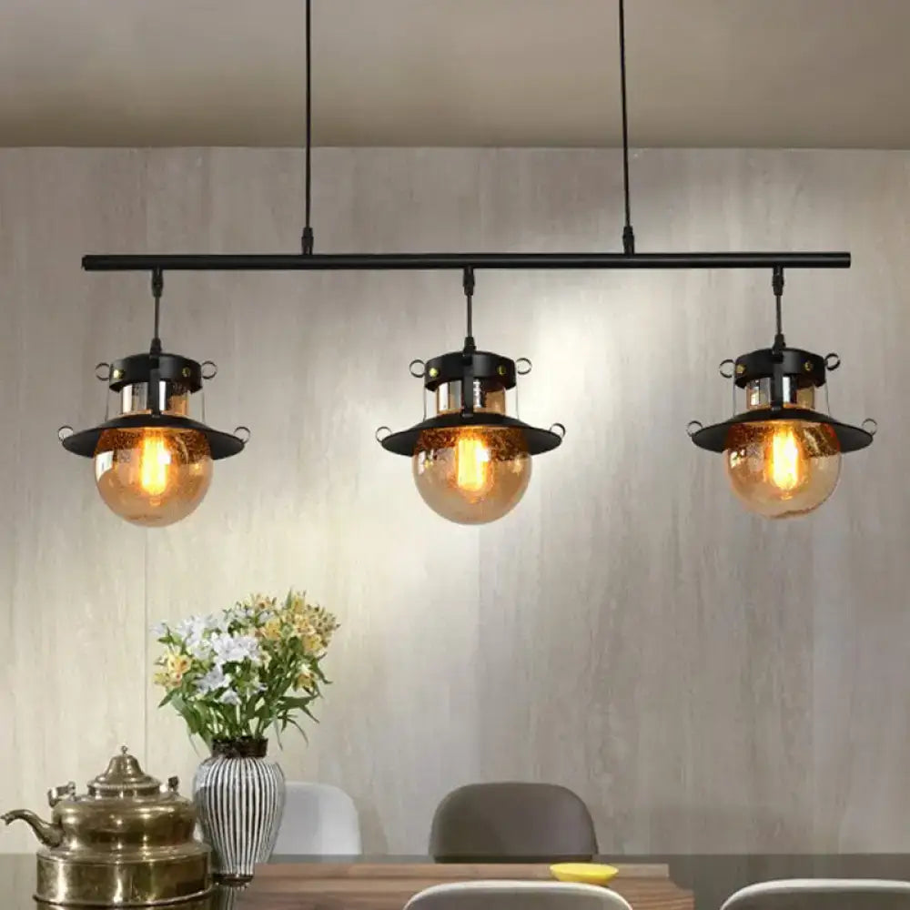 DecorBites 3-light industrial black metal island pendant with flared shade and amber glass globe fixtures
