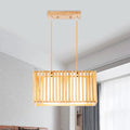 Rectangular rubber wood cuboid cage pendant light with vertical slats and warm finish for dining table lighting