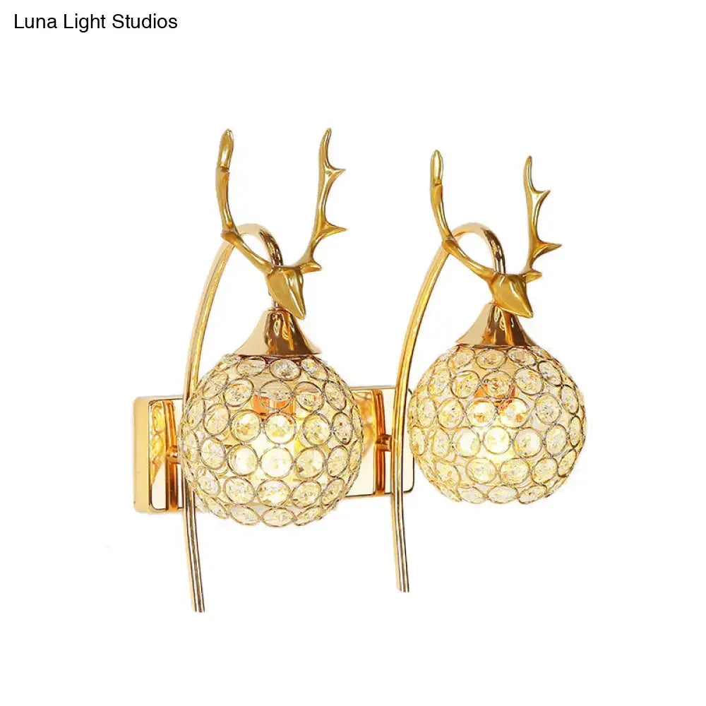 Gold-toned deer wall sconce with crystal dome shade and white chrome accents ideal as a bedroom wall light