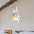 White deer antler-themed wall sconce with crystal dome shade and chrome wall light for bedroom use