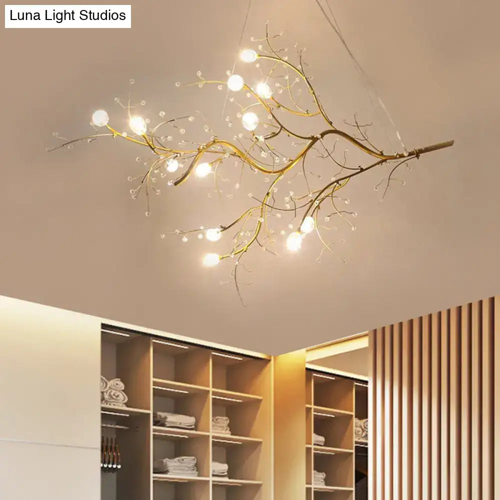 Golden situla metallic branch chandelier with crystal bead accents and warm glowing bulbs for boutique lighting