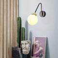 Mid century black and brass wall sconce with spherical frosted opal glass shade compatible with e26 e27 bulbs