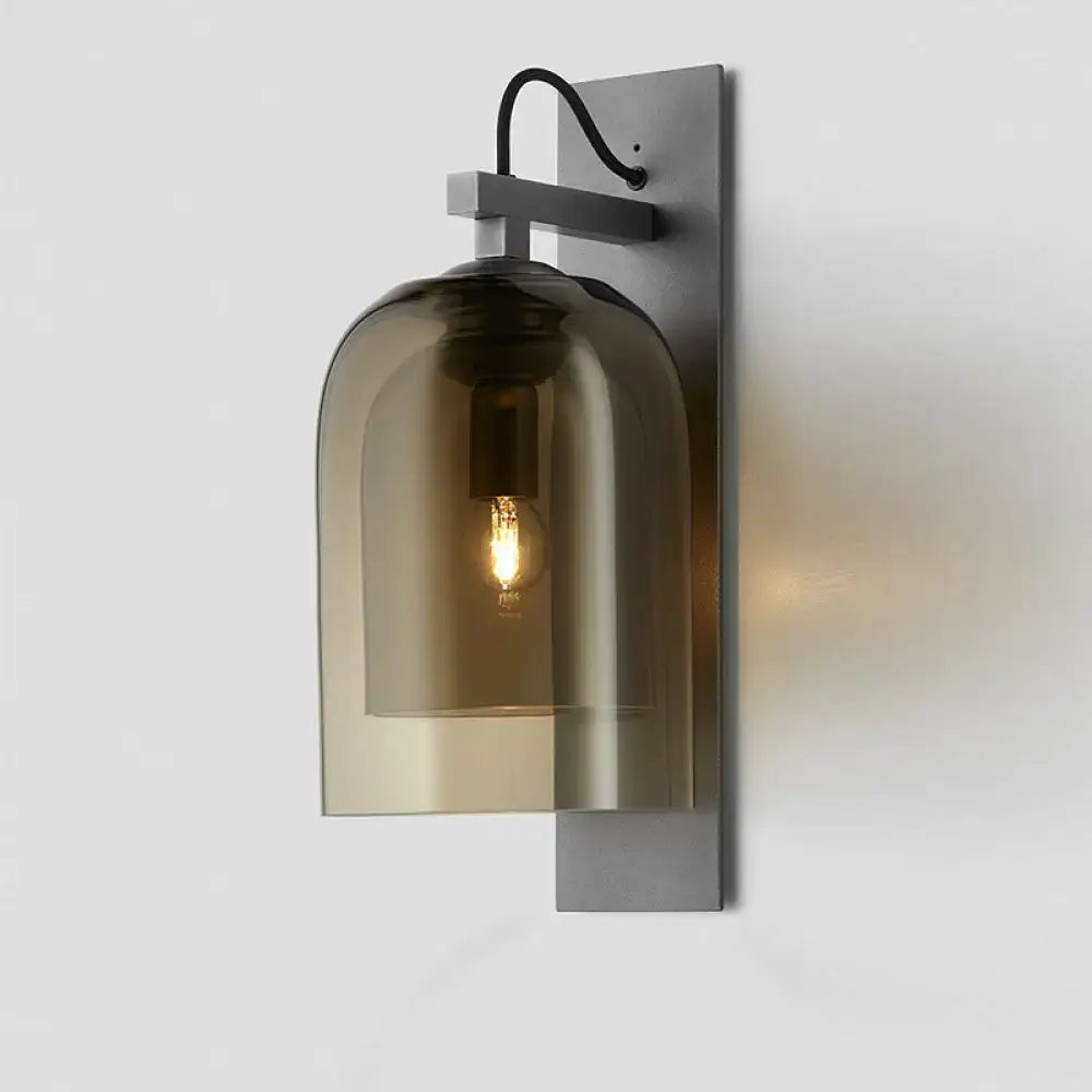 Mid-century black wall sconce with smoked dome glass shade living room