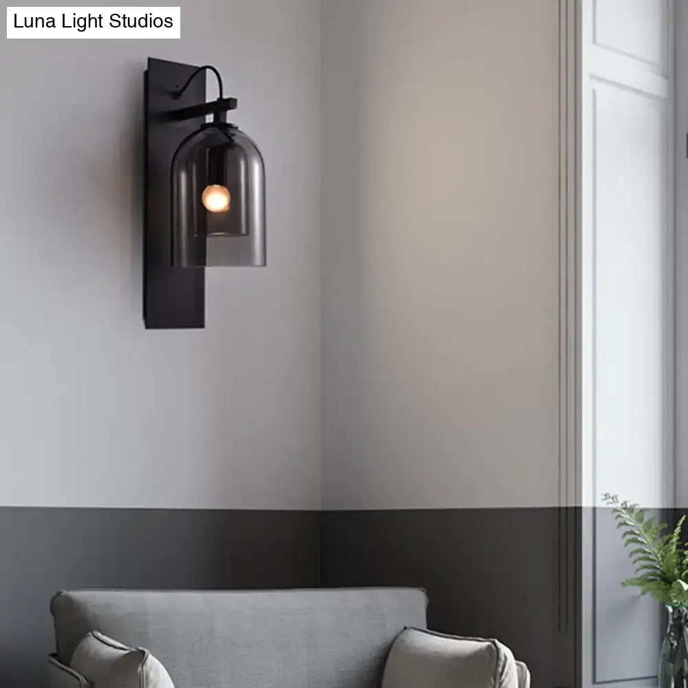 Mid-century black wall sconce with smoked dome glass shade living room