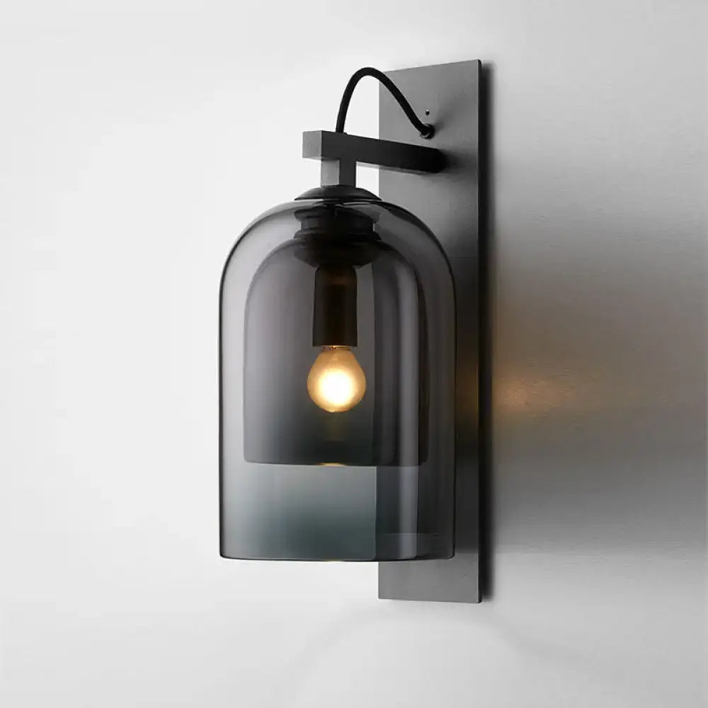 Mid-century black wall sconce with smoked dome glass shade living room