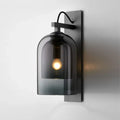 Mid-century black wall sconce with smoked dome glass shade living room