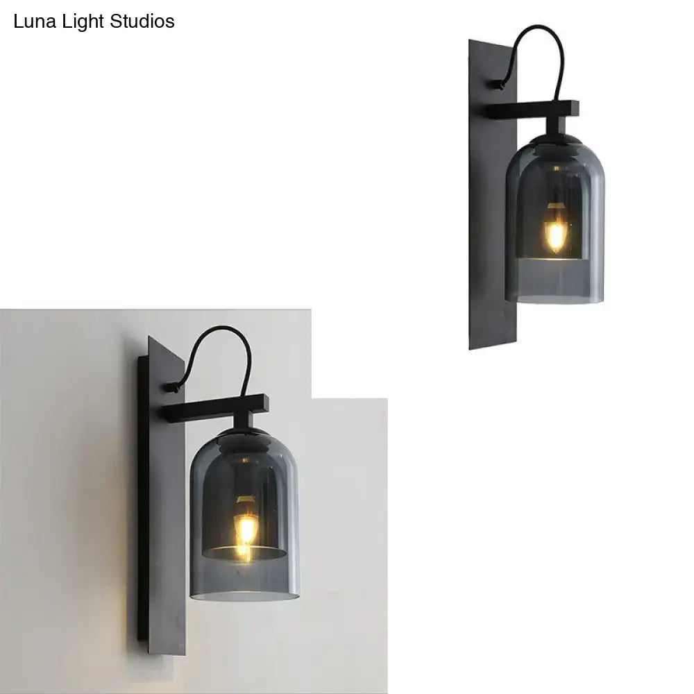 Mid-century black wall sconce with smoked dome glass shade living room
