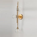 Mid century brass finish 3 light wall sconce with clear glass orb shades vertically arranged along slender arm