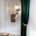 Minimal brass and crystal wall lamp featuring a sleek curved design and cone shade for bedroom lighting