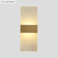 Minimalist acrylic gold wall sconce with a warm diffused glow and central gold-toned metallic accent bar wall lamp
