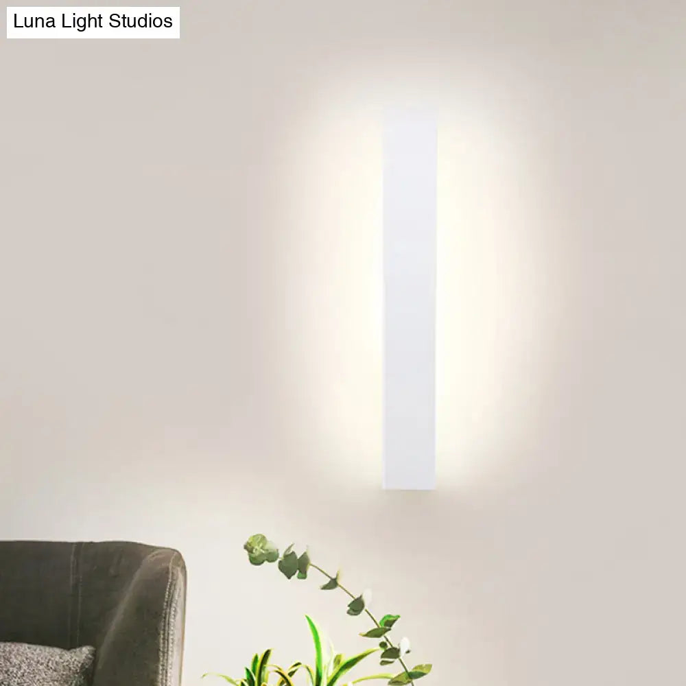 Modern white rectangular led wall sconce with aluminum shade direct wired emitting soft warm glow for bedroom use