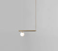 Minimalist brass ceiling light with a white glass globe suspended from a horizontal bar for kitchen island use