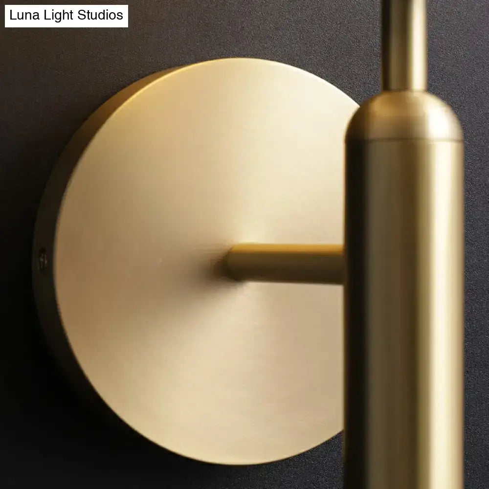 Minimalist brass wall sconce with cream glass shade for living room