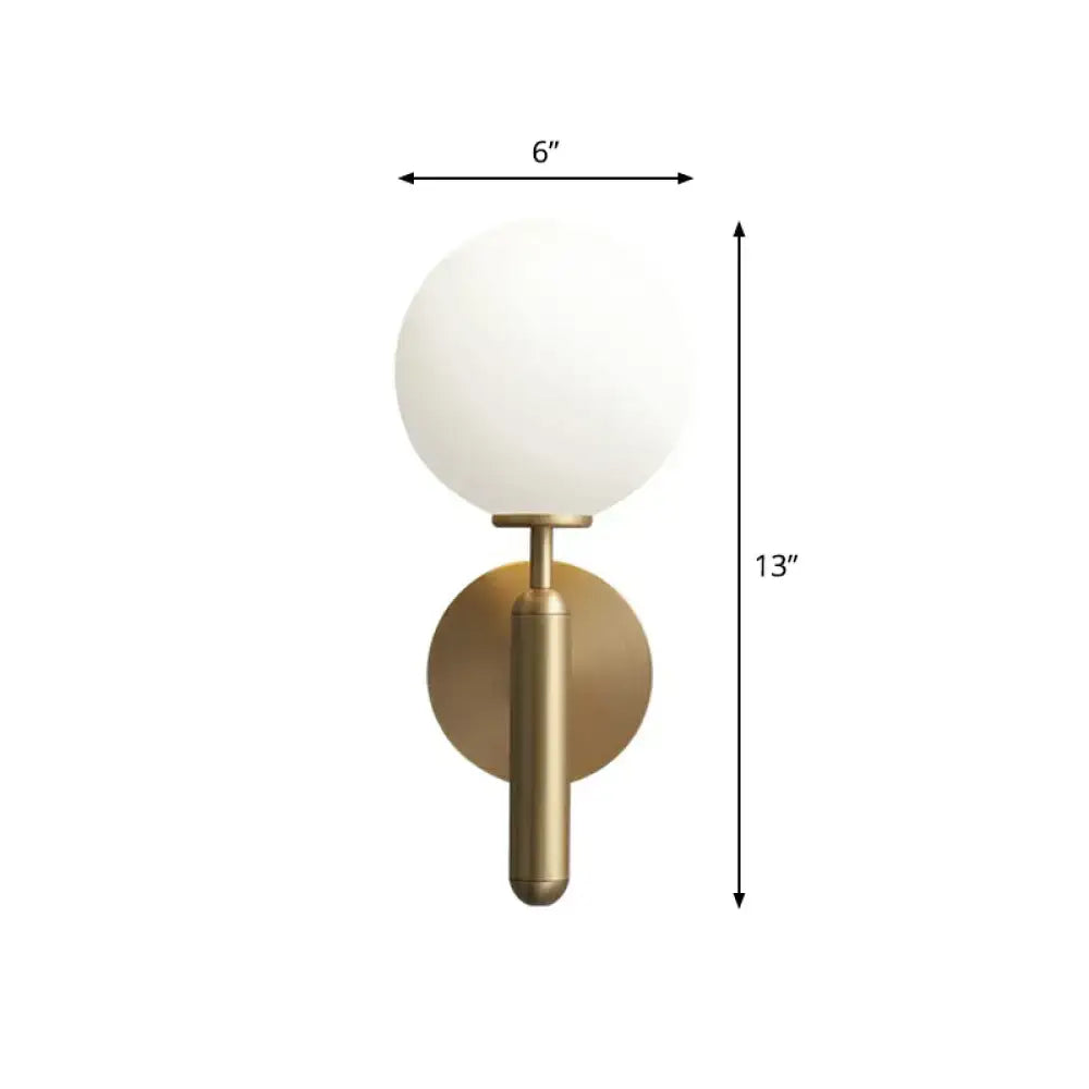 Minimalist brass wall sconce with cream glass shade for living room
