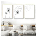 Three framed black and white minimalist dandelion canvas wall art pieces with thin gold frames for wall decoration