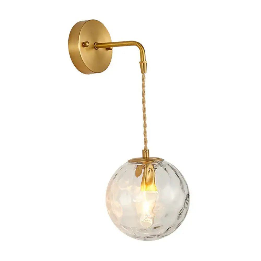 Minimalist gold ball sconce with hammered glass shade bedroom light