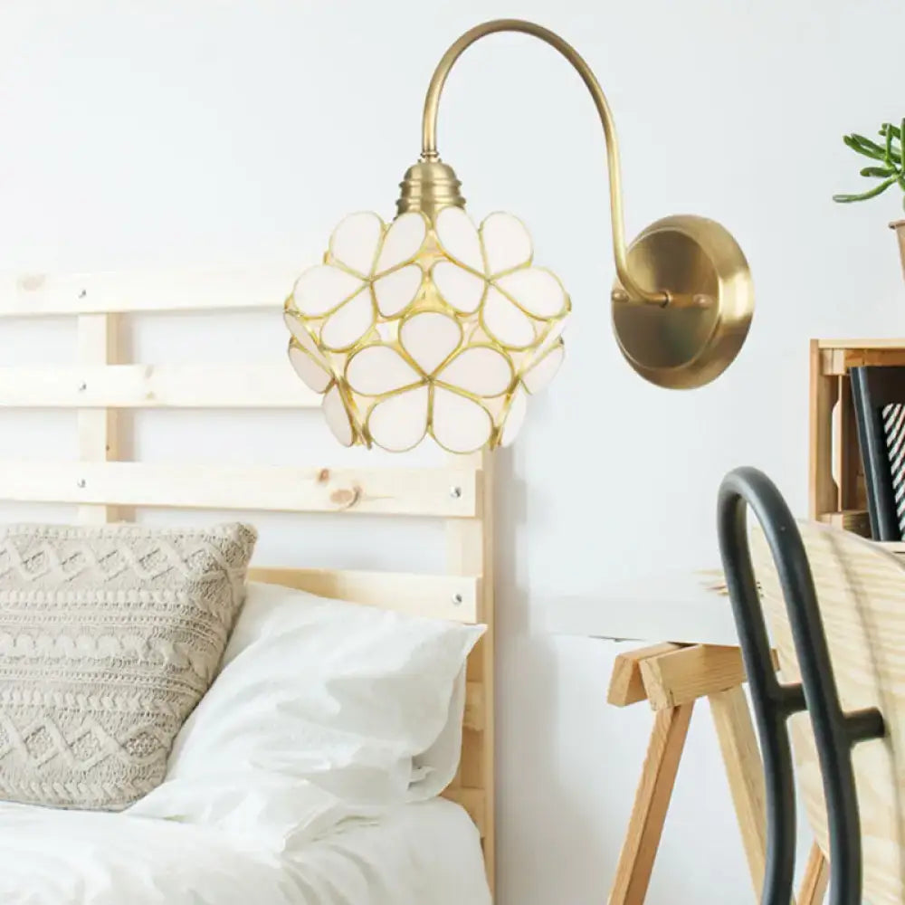 Minimalist gold floral wall sconce with glass shade for living room
