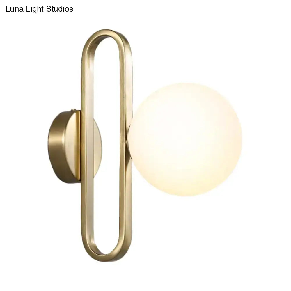 Minimalist gold oval arm wall light with cream matte glass bedroom sconce
