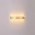 A minimalist gold plated rectangular led wall sconce with warm ambient light for living room and bar use