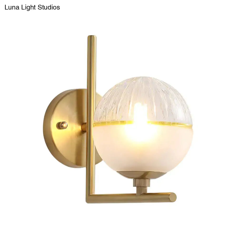 Minimalist gold wall lamp with textured glass globe bedroom fixture