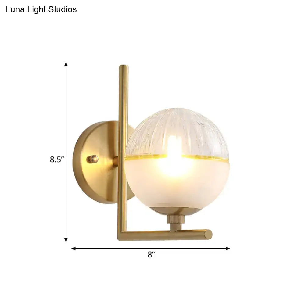 Minimalist gold wall lamp with textured glass globe bedroom fixture