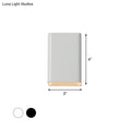 Minimalist wall lamp with a matte white cube shade and warm brass base designed as a sleek bedroom sconce