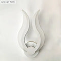 Minimalist white flame wall sconce with sleek minimalist design and LED light for bedroom use