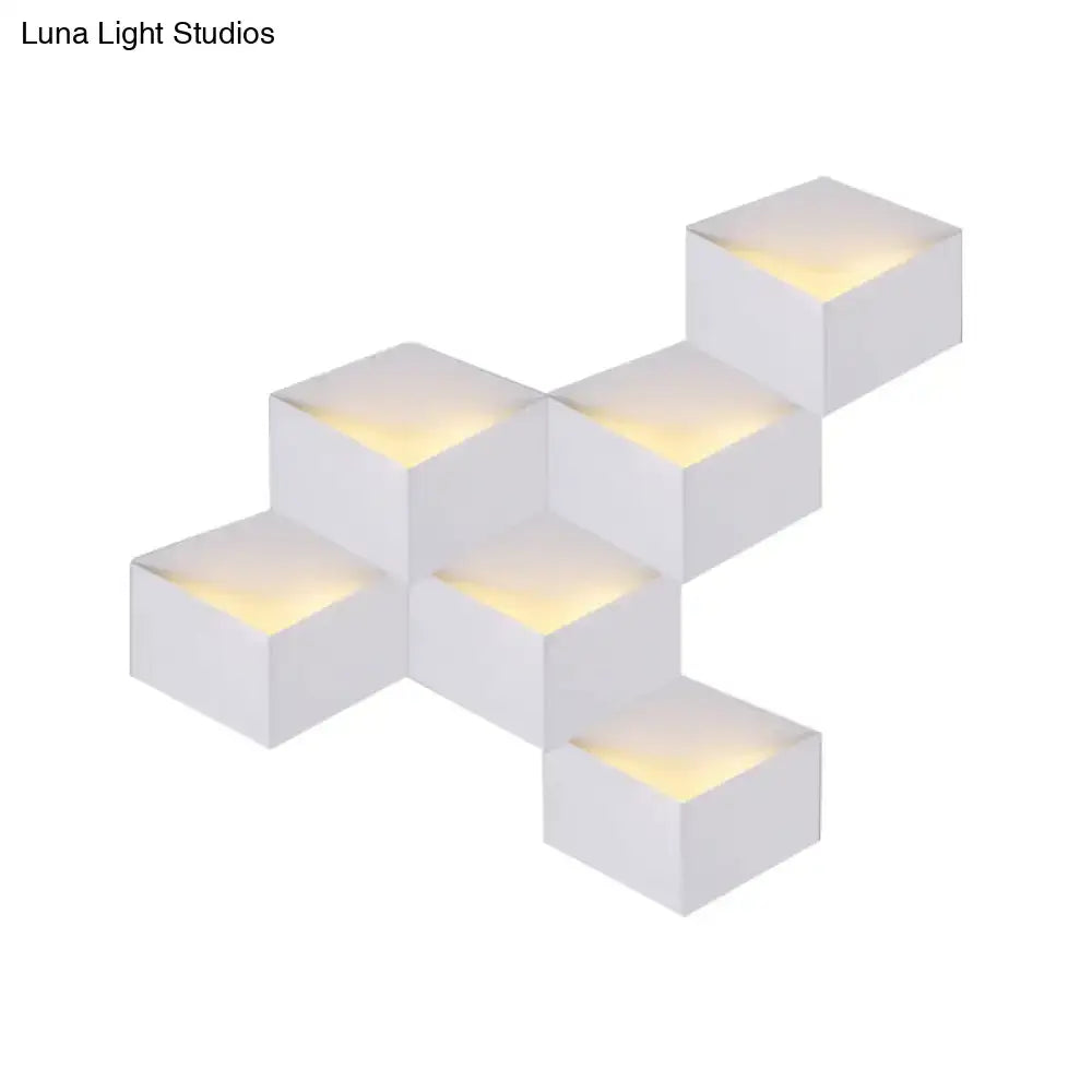 Minimalist white metallic geometric wall lamp with cube-shaped LED sconces emitting warm yellow light for corridor