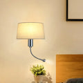 A sleek modern beige fabric flush wall sconce with curved metallic arm for bedroom reading light