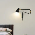 Modern black and brass wall light with articulated arms and backplate width designed for bedroom or studio use with e26 bulb base