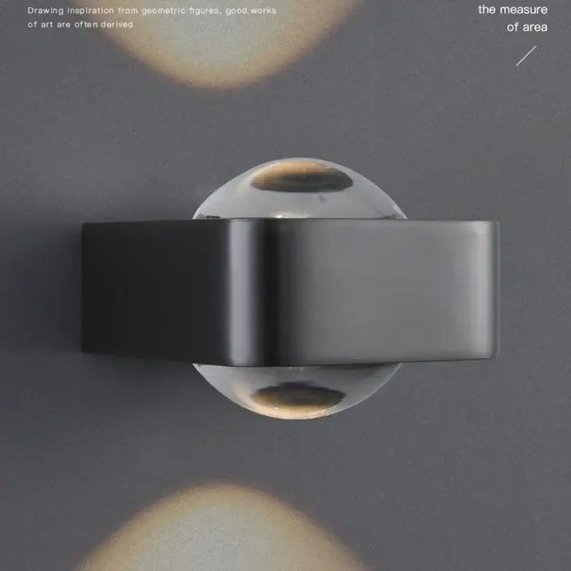 Modern black and copper bedroom wall lamp with glass dome
