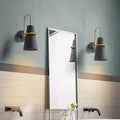 Modern black and gold conical sconce with wall mount design for elegant dining room lighting