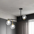 DecorBites™ modern black metal island chandelier with three clear glass ball shades and gold accents for dining room