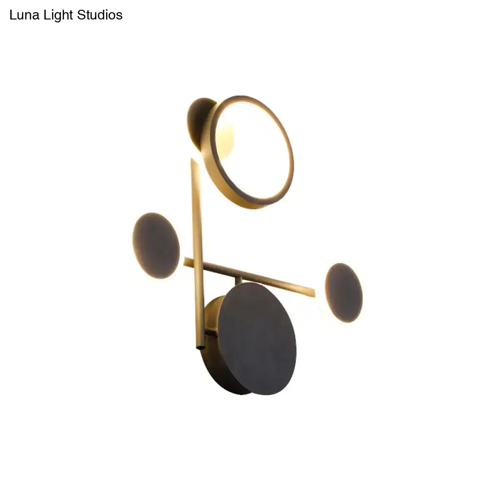 Modern black and white metallic round led wall sconce with gold-toned circular lights and matte black disc accents for living room