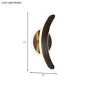 Modern crescent-shaped wall mounted lamp with brushed brass base and dark bronze arm providing white warm light