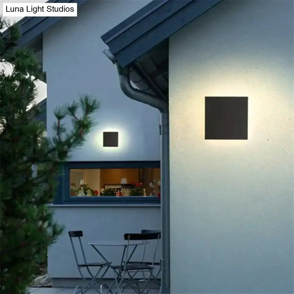 Modern black circular waterproof wall lamp with sleek square sconce and warm diffused lighting for bedroom use
