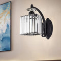 Modern style black wrought iron wall light with curved arm and cylindrical crystal cage for living room use