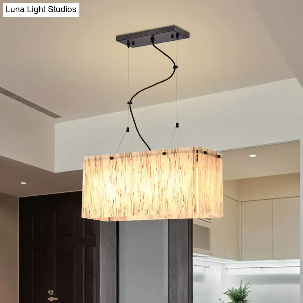 Modern black dining room pendant light with amber glass shade